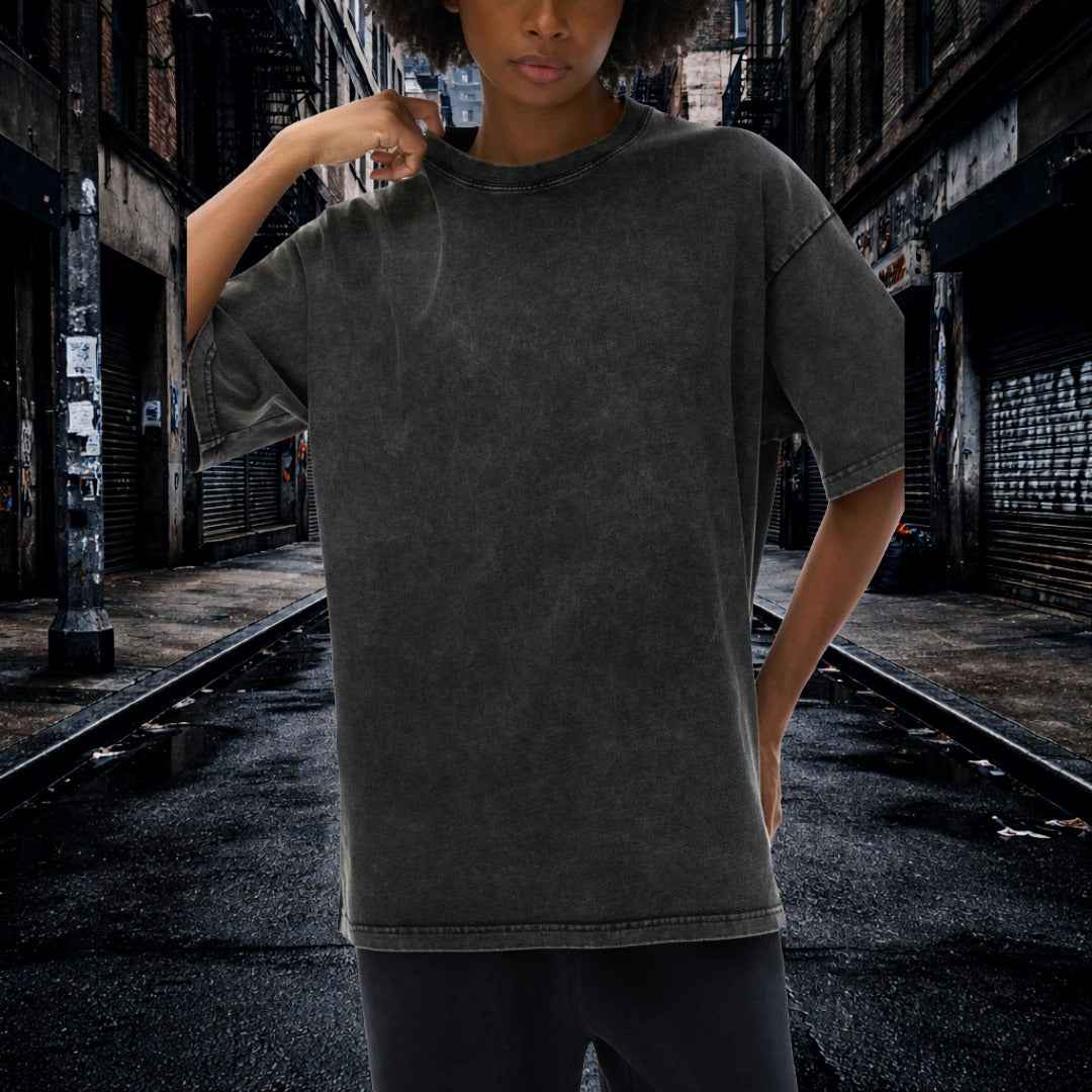 Person wearing a dark gray t-shirt in an urban alleyway.