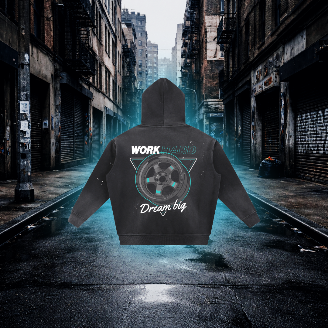 Hoodie with 'Work Hard, Dream Big' text and graphic on a city street background Work Hard Dream Big Wheels Inspired Hoodie – Premium Automotive Streetwear Hoodie