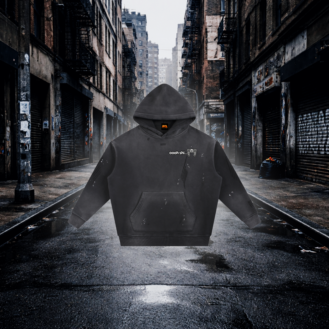 Black hoodie with 'Ohh Shi...' text on a desolate urban street