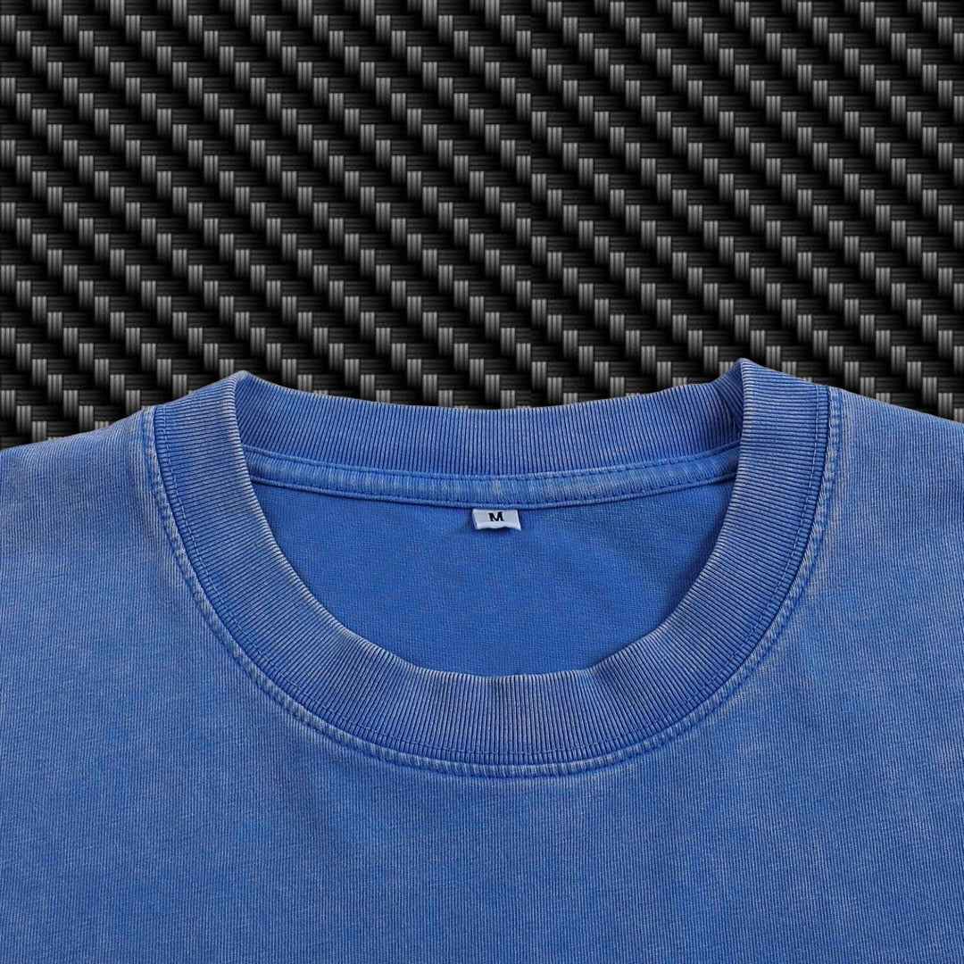 Close-up of a blue shirt collar with a carbon fiber pattern in the background