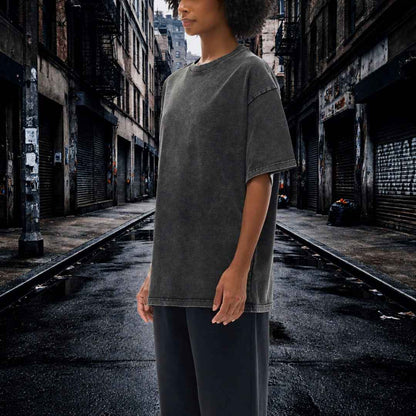 Person wearing a gray t-shirt standing in an urban alleyway.